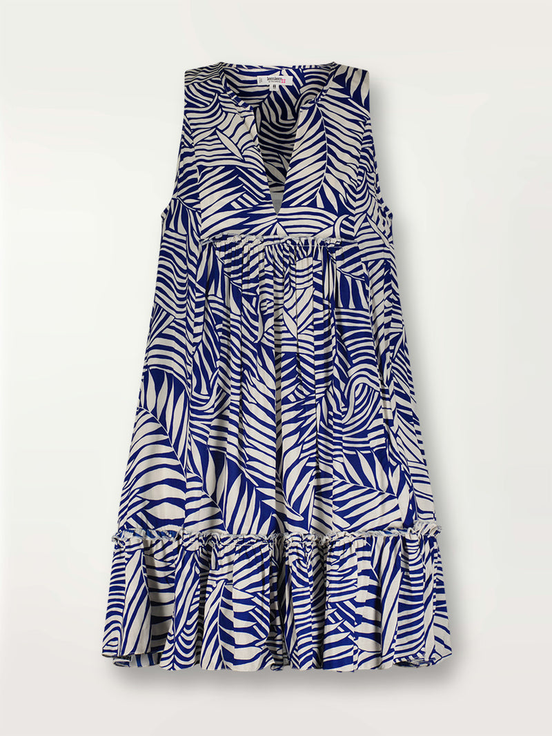 Product shot of the Palm Leaf Bib Dress featuring palm tree patterns on a rich blue background.