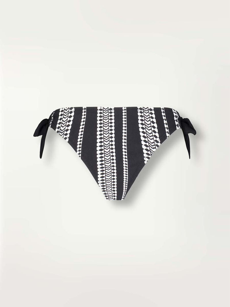 Product shot of the Luchia Side Tie Bikini bottom in black with graphic white diamond and arrows.