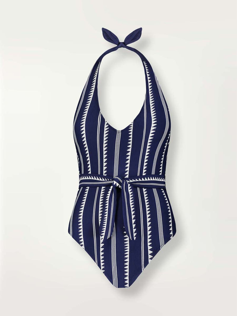 Product shot navy Nunu deep v belted one piece swimsuit with white triangles and stripesWoman wearing a navy Nunu deep v belted one piece swimsuit with white triangles and stripes