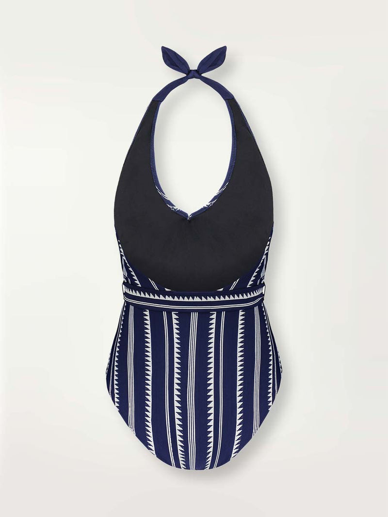 Product shot back view of a navy Nunu deep v belted one piece swimsuit with white triangles and stripes