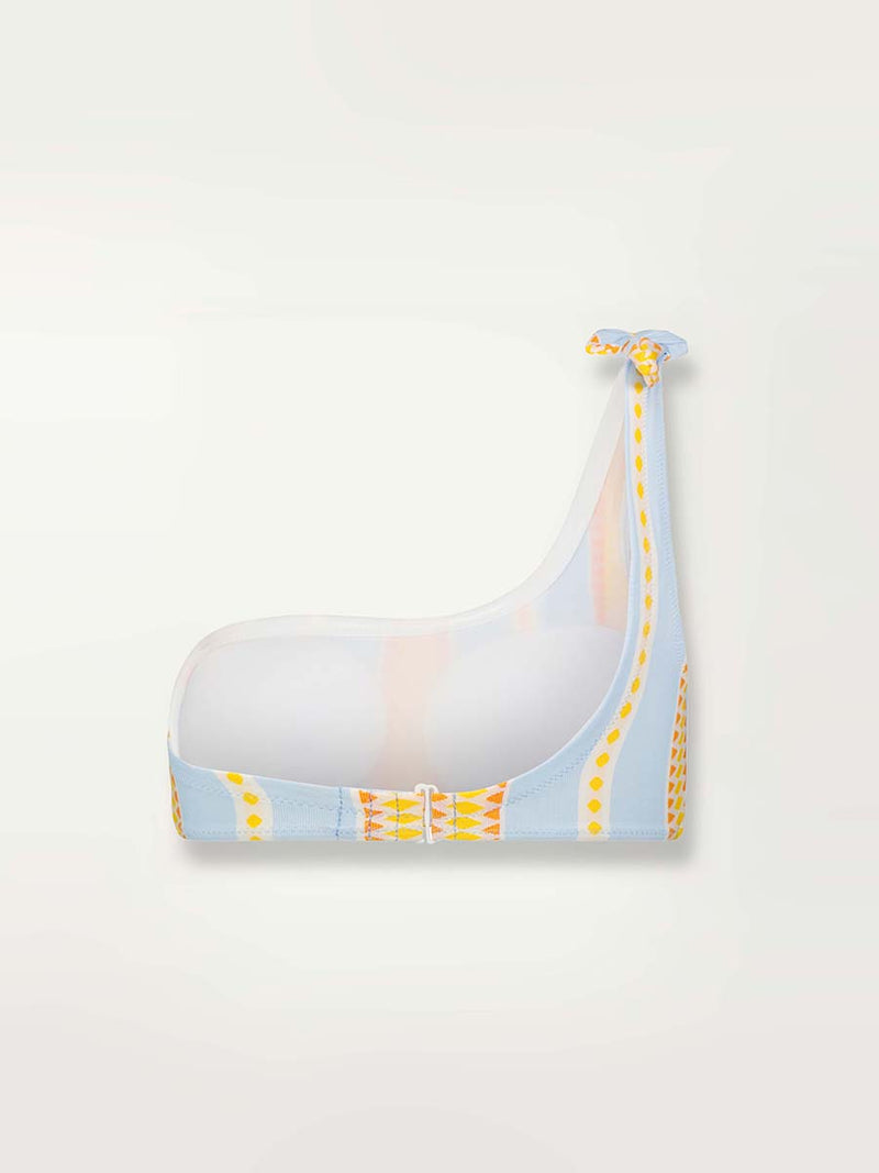 Product shot of the back of the Jemari One Shoulder Top in sky blue featuring yellow and orange diamond patterns 