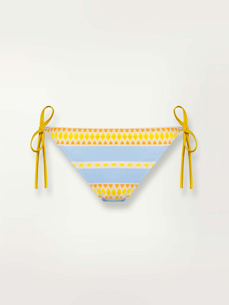 Product shot of the front of the Jemari String Bottom in sky blue featuring yellow and orange diamond patterns .