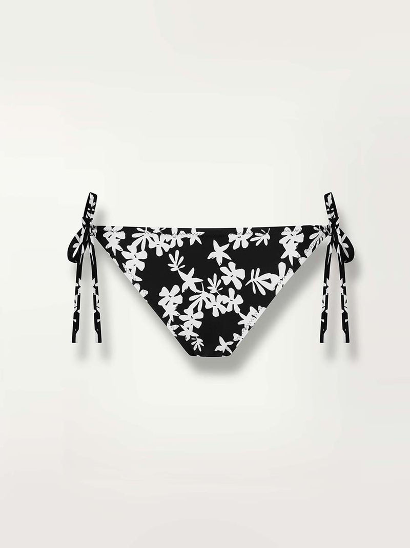 Product shot of the front of the Sea Floral String Bikini Bottom in black featuring white allover floral print 