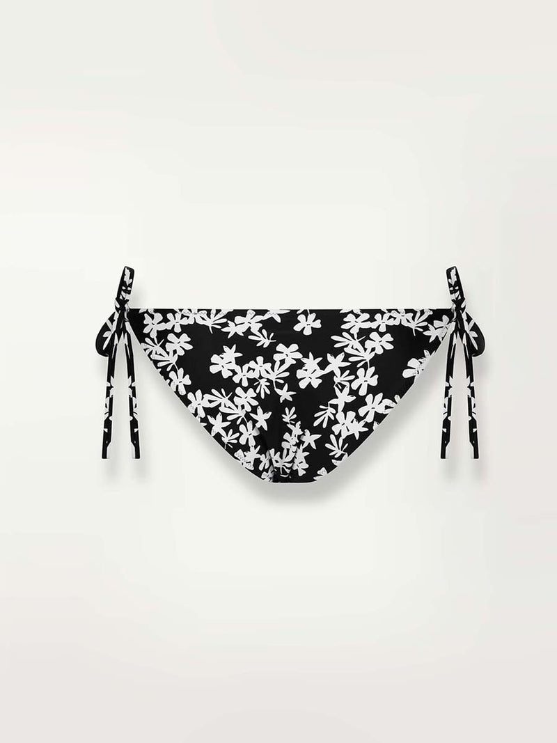 Product shot of the back of the Sea Floral String Bikini Bottom in black featuring white allover floral print 