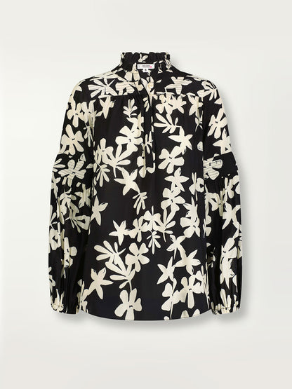 Product shot of the front of the Sea Floral Ruffle Blouse in Black featuring white allover floral print.