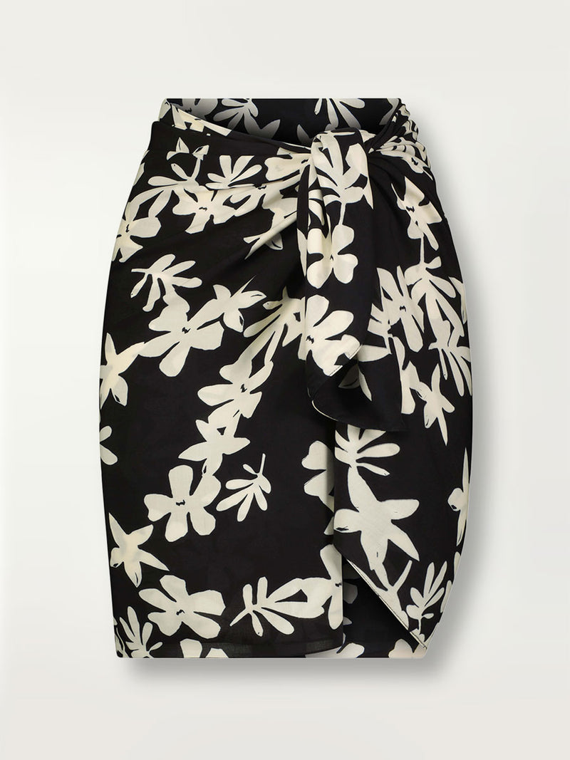 Product shot of the front of the the Sea Floral Sarong around her waist in Black featuring white allover floral print.