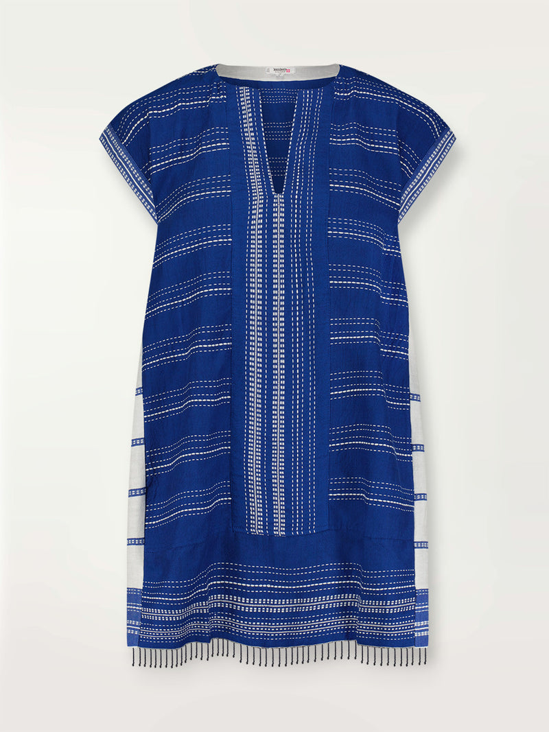 Product shot of the the Inku Caftan Dress featuring textured white dots on deep blue background.