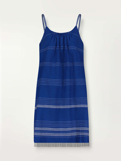 Product shot of the Inku Swing Dress featuring textured white dots on deep blue background.