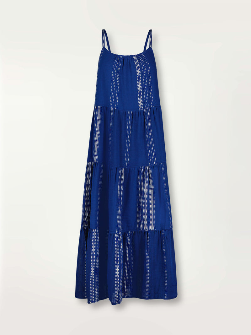 Product shot of the Inku Caftan Dress featuring textured white dots on deep blue background.