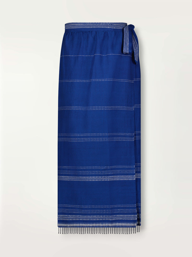 Product shot of the Inku Wrap Skirt featuring textured white dots on deep blue background.